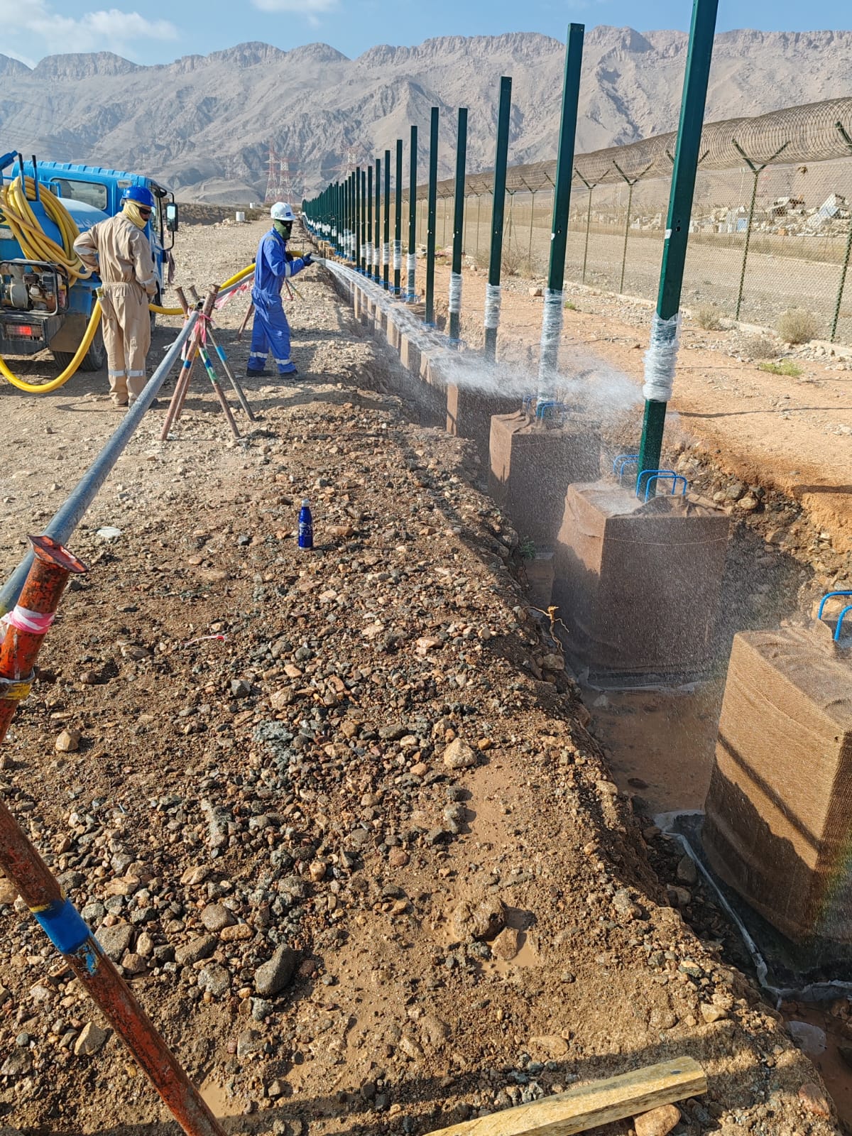 Pipeline trenching and installation work in desert.